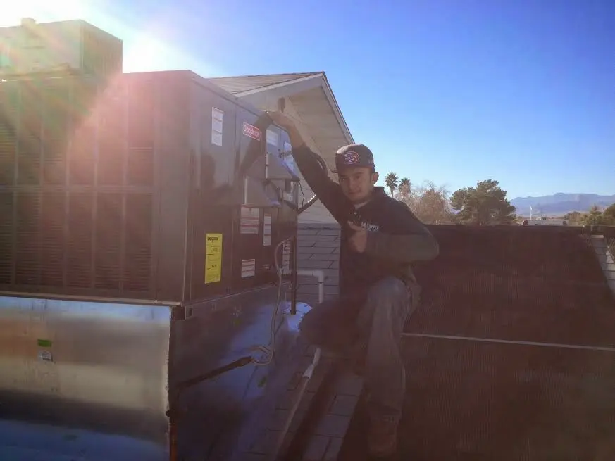 HVAC technician performing Boiler Repair on a rooftop unit in South Hill